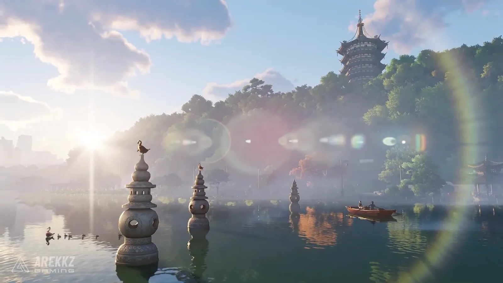 Ananta Chongxiao lake with small stone pagodas standing in the water, a rowing boat and a tall pagoda on the wooded hill behind